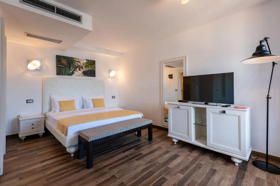 Deluxe Suite bedroom with sea view at Forte Rose